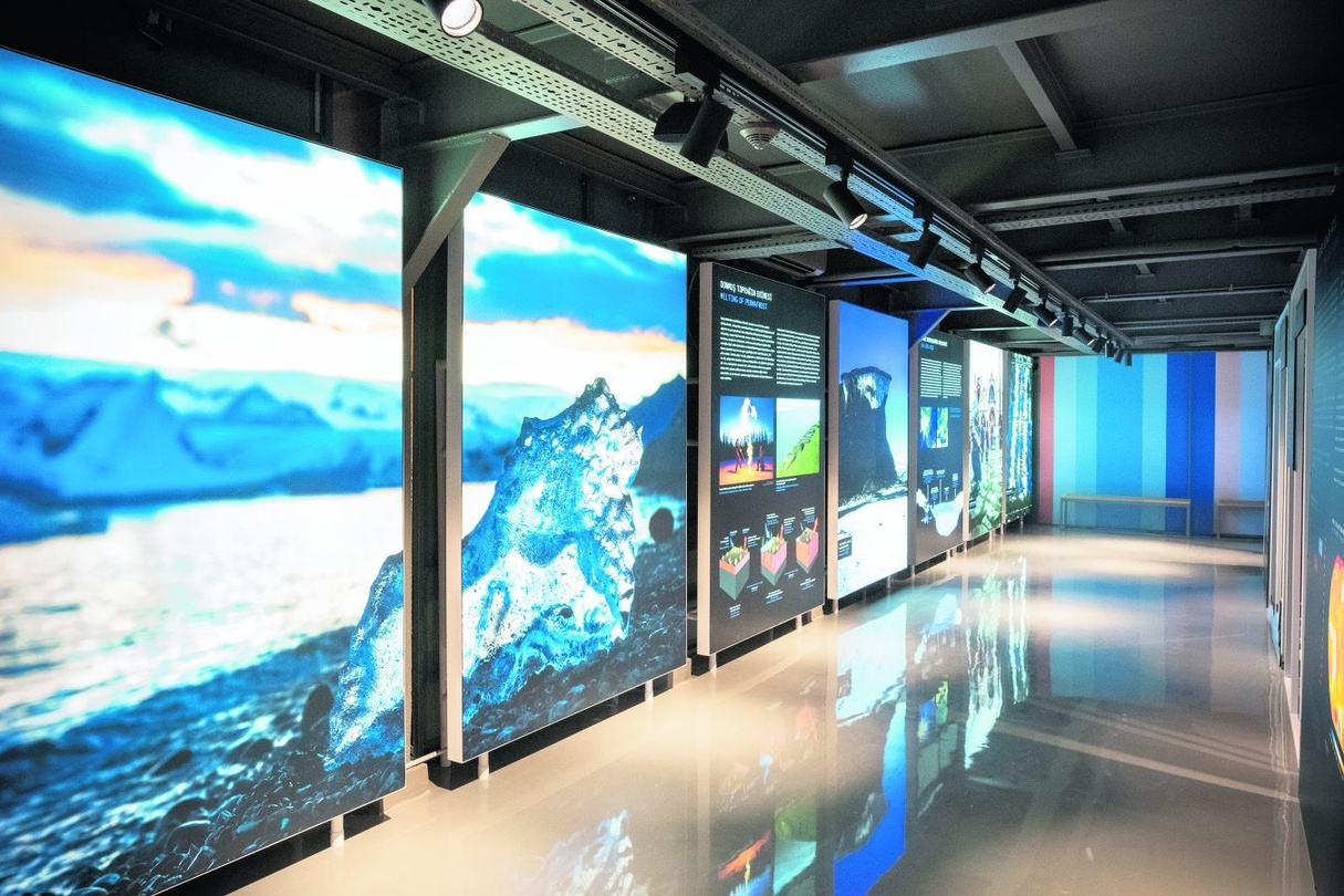 Museum exhibit panels with stainless steel framing and illuminated graphics, fabricated by Alice Scenic Studios.