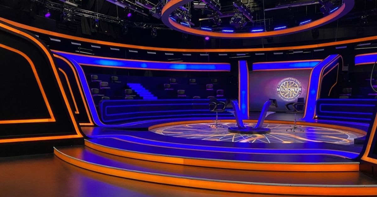 Broadcast studio set design for a modern game show with curved LED platforms and audience seating